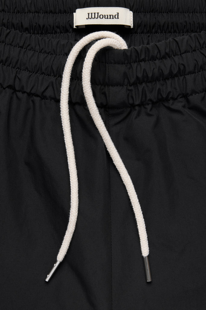 パンツ jjjjound Tracksuit Bottom / Grey / Large WINDBREAKER_BOTTOM_BLACK_02_UP